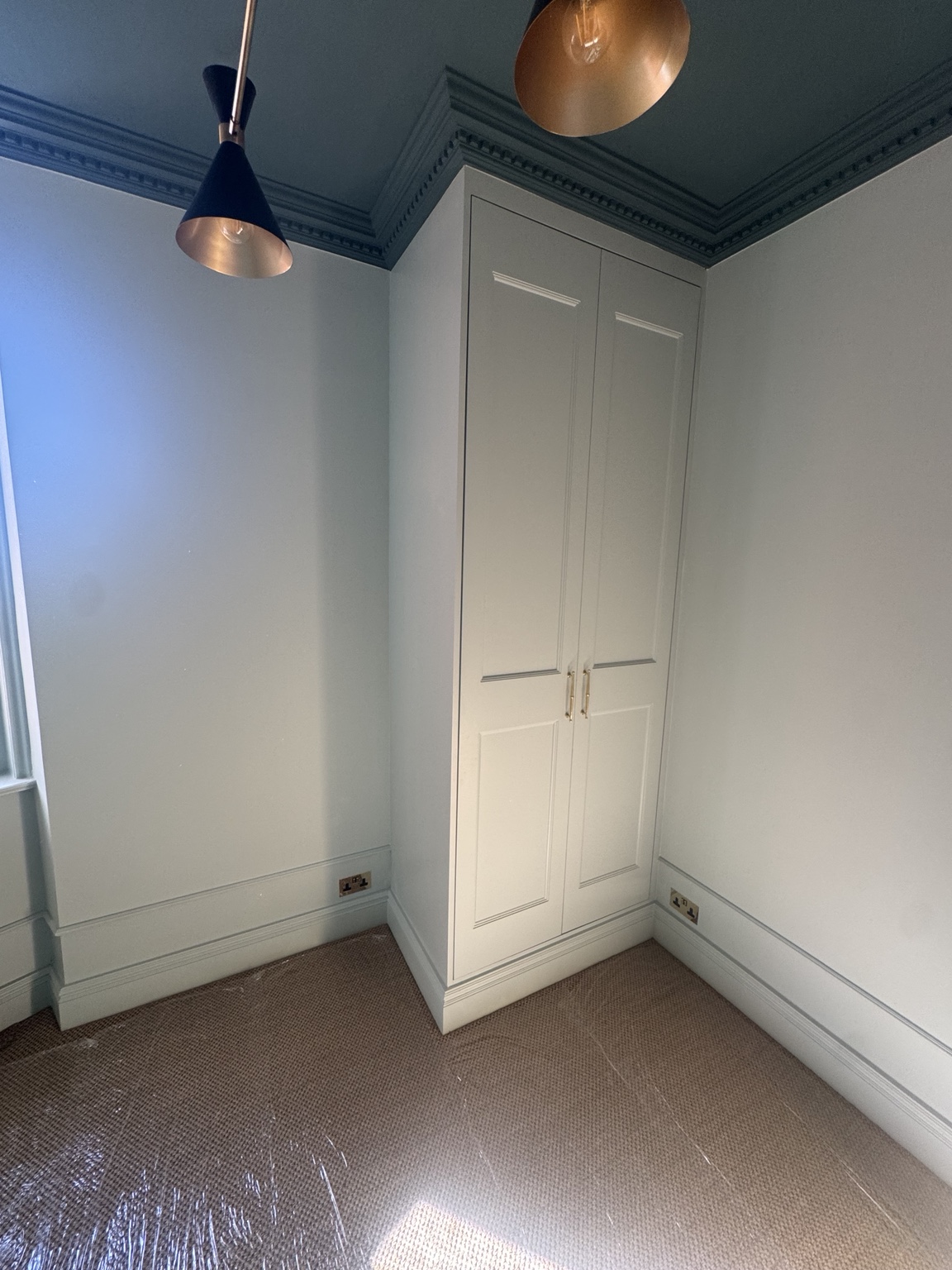 Smaller two-door painted shaker wardrobe in Bedroom 3 at York Mansion, Battersea