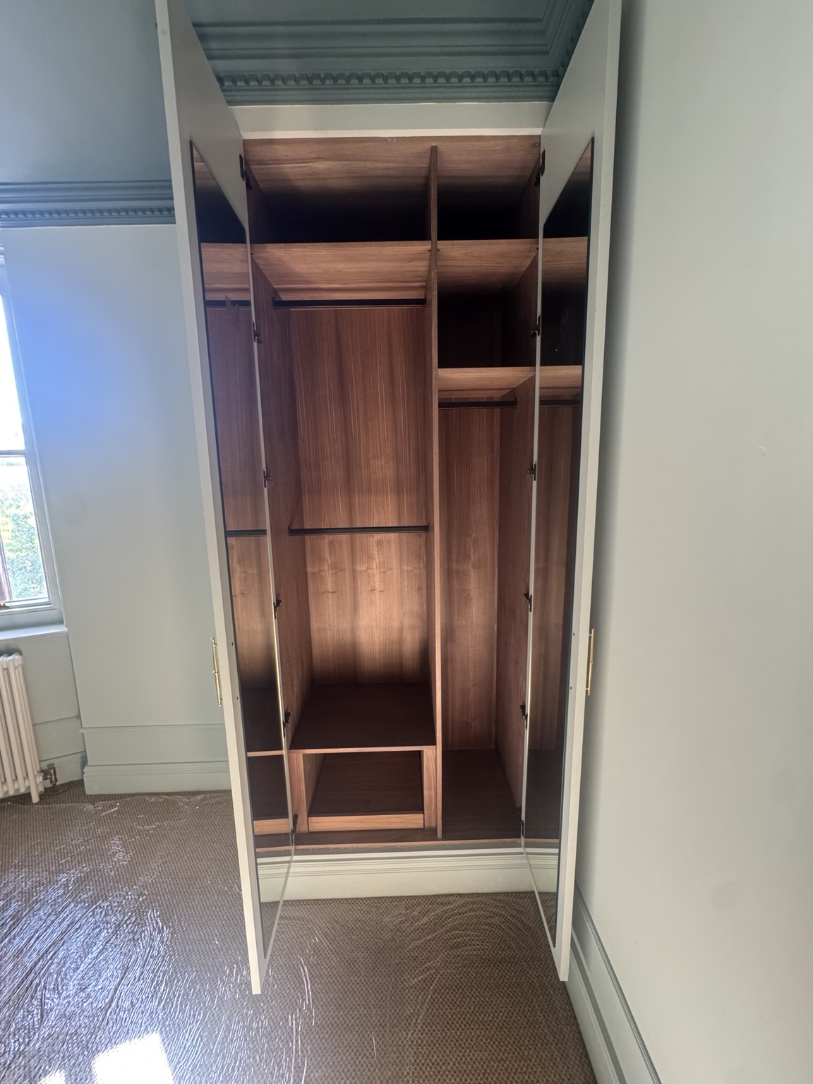 Bedroom 3 walnut veneer interior with black hanging rails, shelving and mirrored inner doors