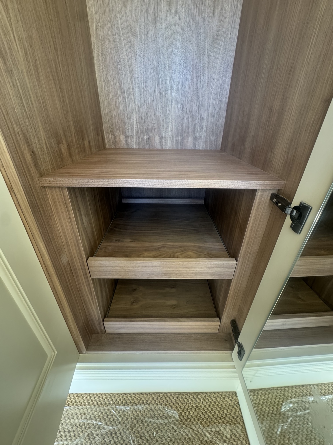 Close-up of walnut pull-out storage in Bedroom 2