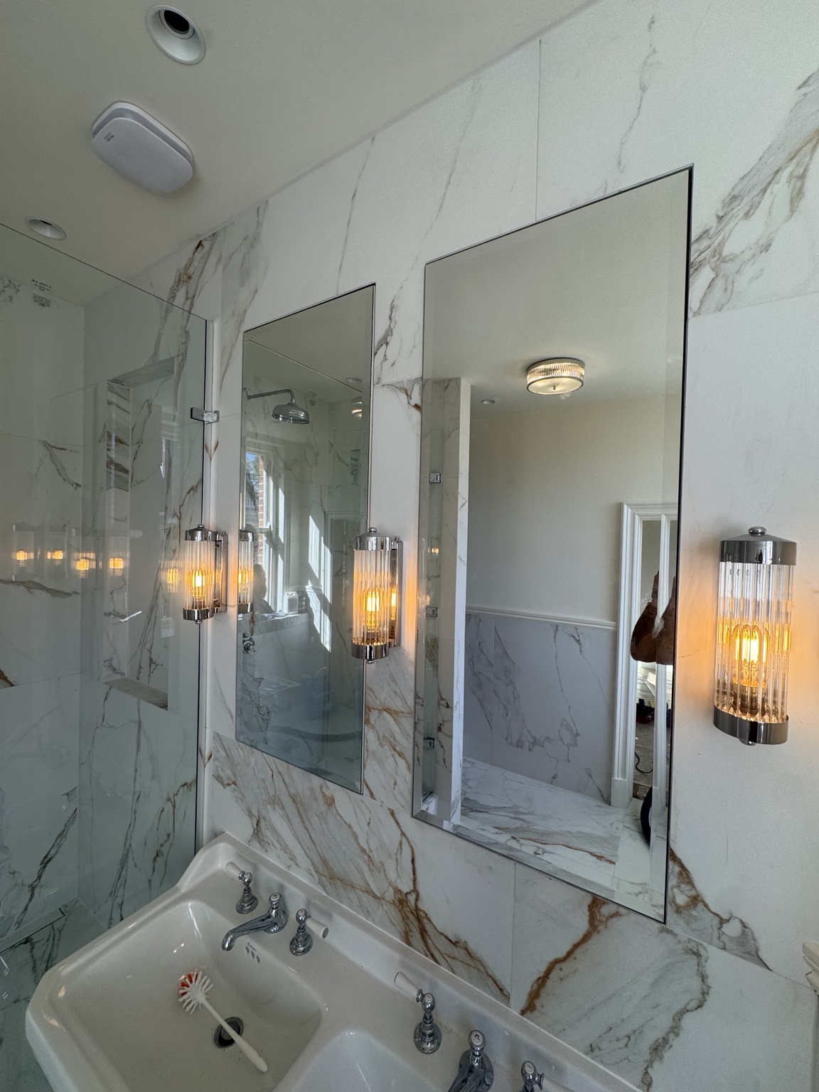 Two bevelled mirrored cabinets above the basins in the master en suite