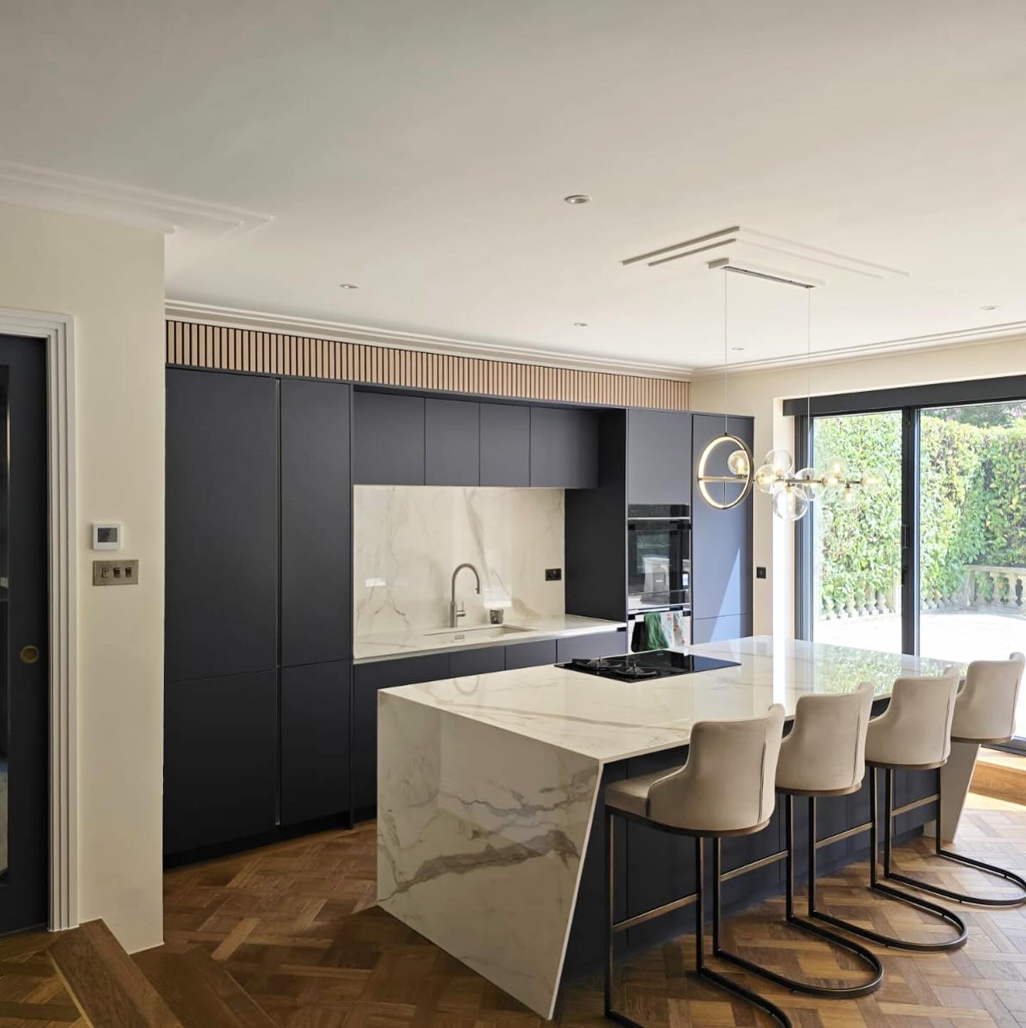 Completed graphite supermatt kitchen with Porcelanosa Calacatta marble island at Dukes Wood Drive, Gerrards Cross