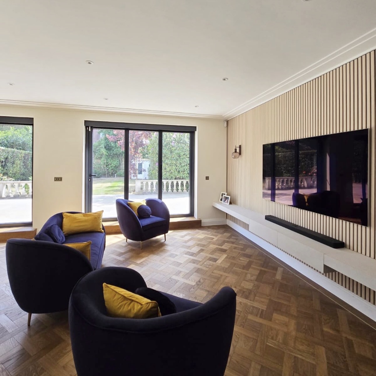 Side view of the acoustic panelling and continuous floating shelf beneath the television
