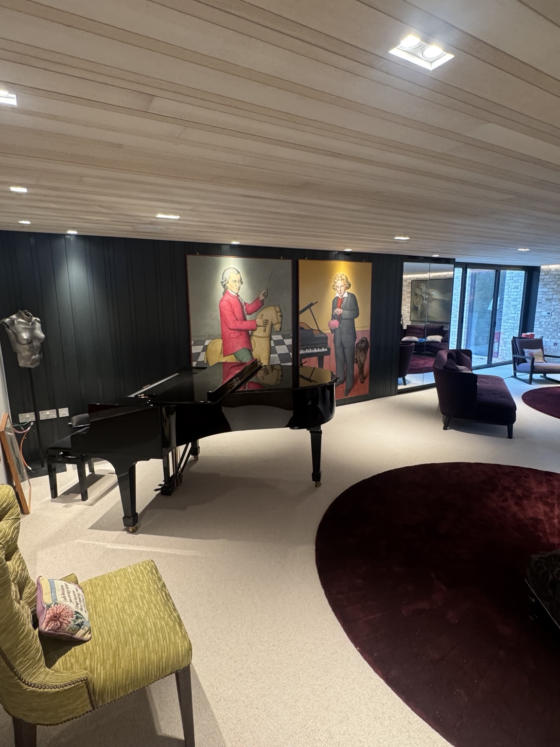 Piano against dark wall panelling with bespoke oak veneer ceiling overhead