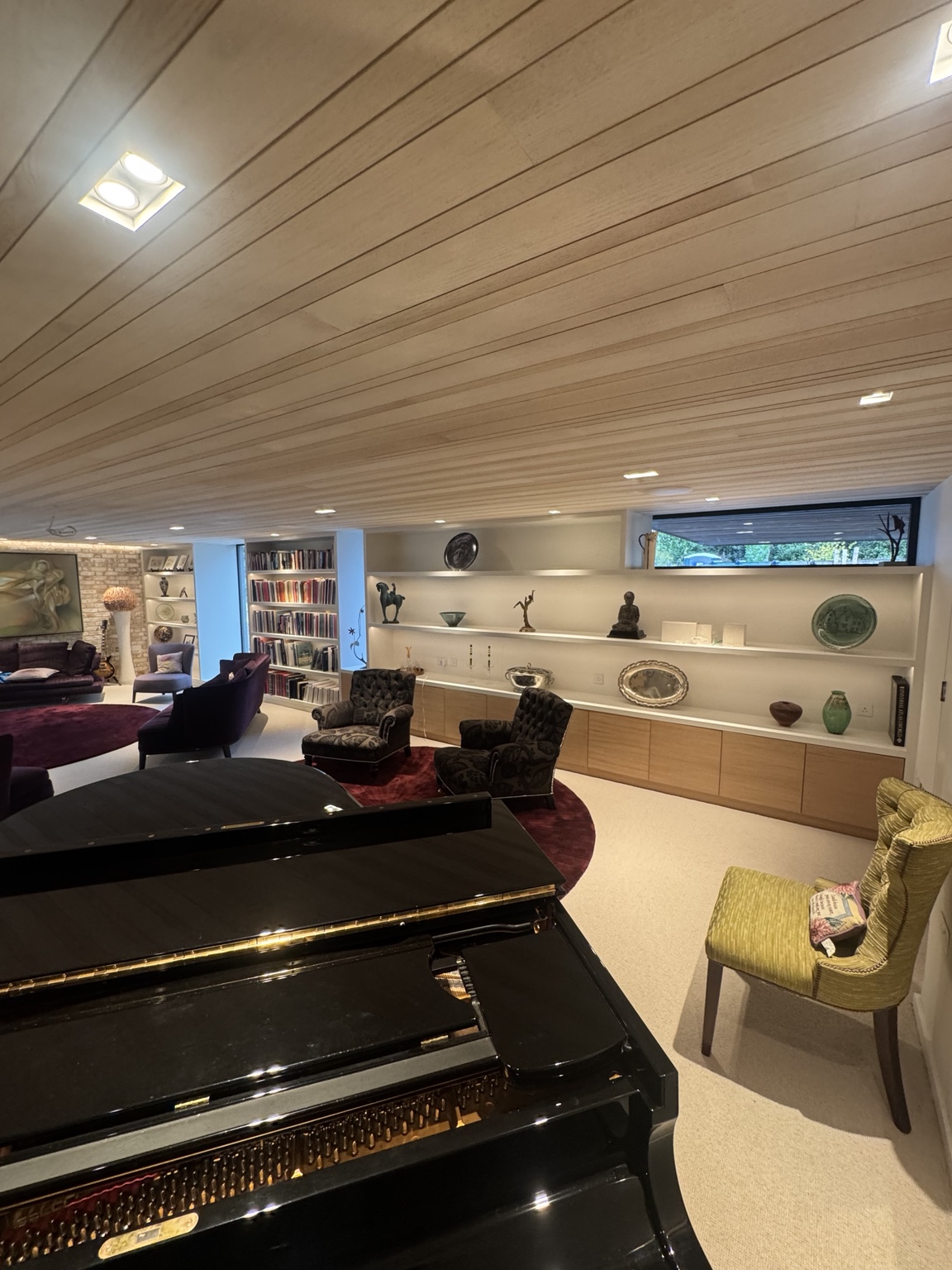 Marlow music room with bespoke oak veneer ceiling panels, piano and illuminated display shelving