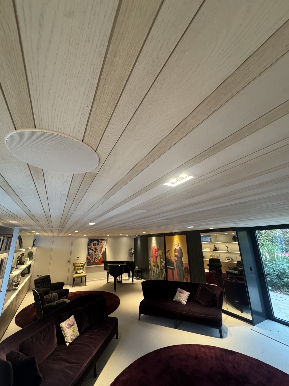 Close view along the oak veneer ceiling panels with integrated lights