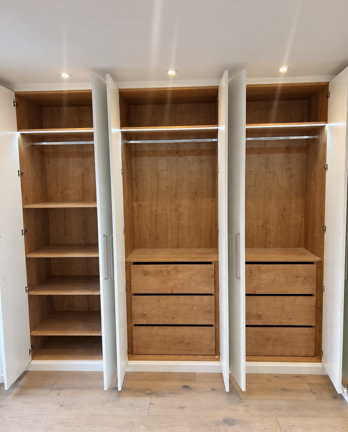 Installed shelving, hanging rails and LED lighting inside the bedroom 2 wardrobe