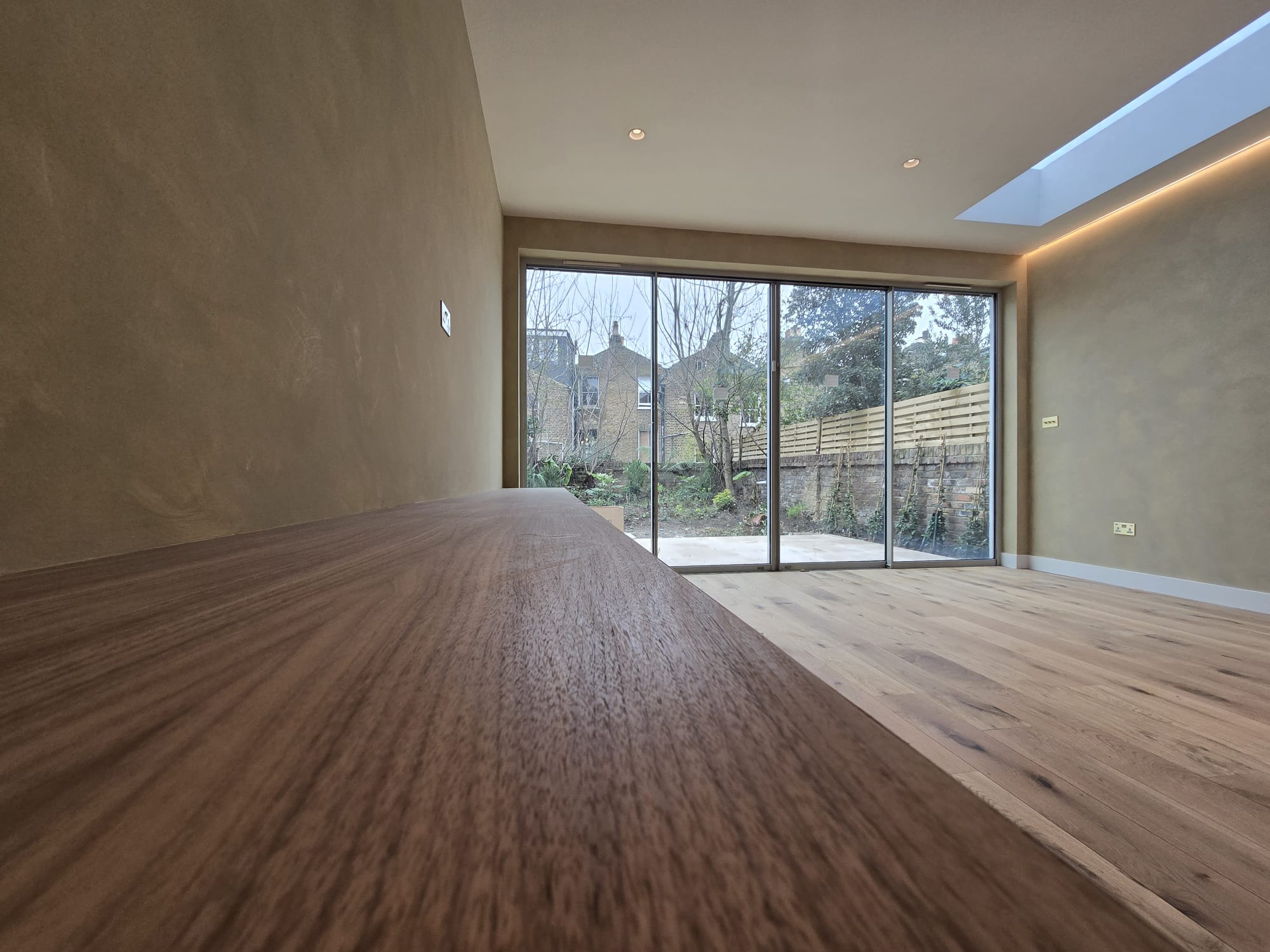 Close view of the walnut grain and long media cabinet top