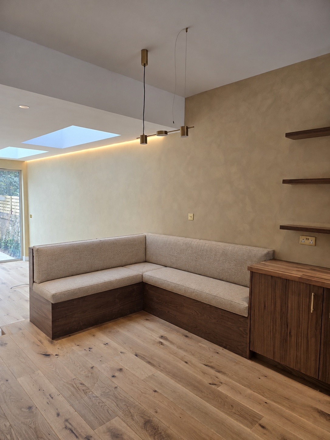 Large fitted L-shaped bench with upholstered seat and back cushions