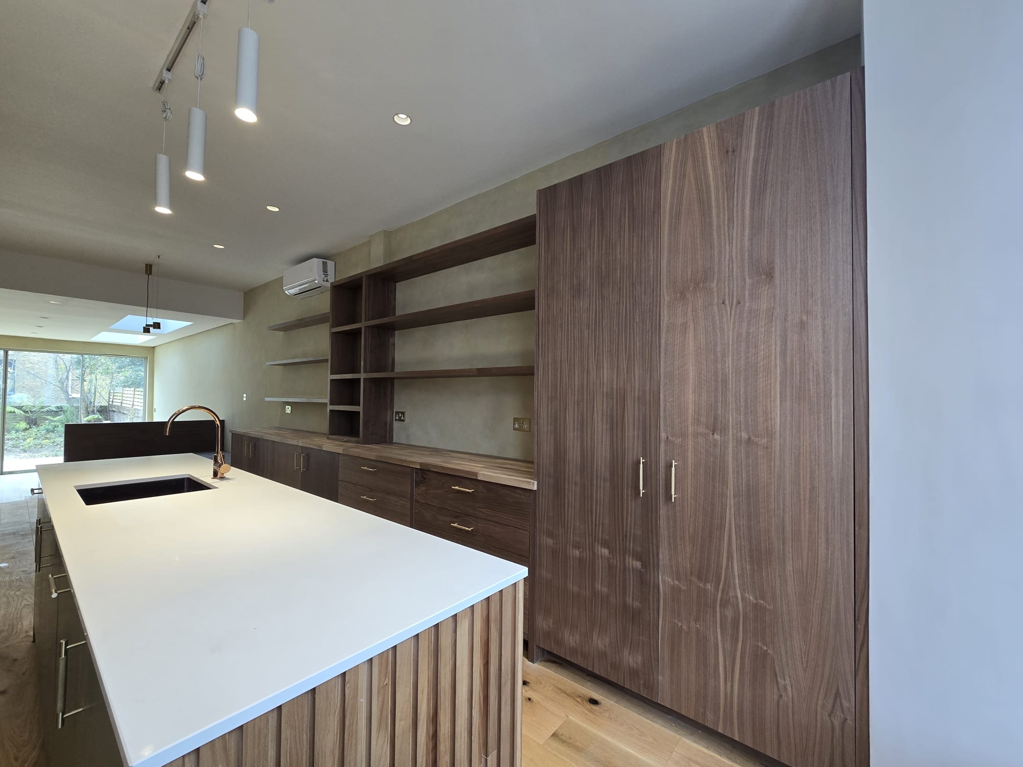 Walnut veneer kitchen with oak acoustic island and quartz worktop in Richmond