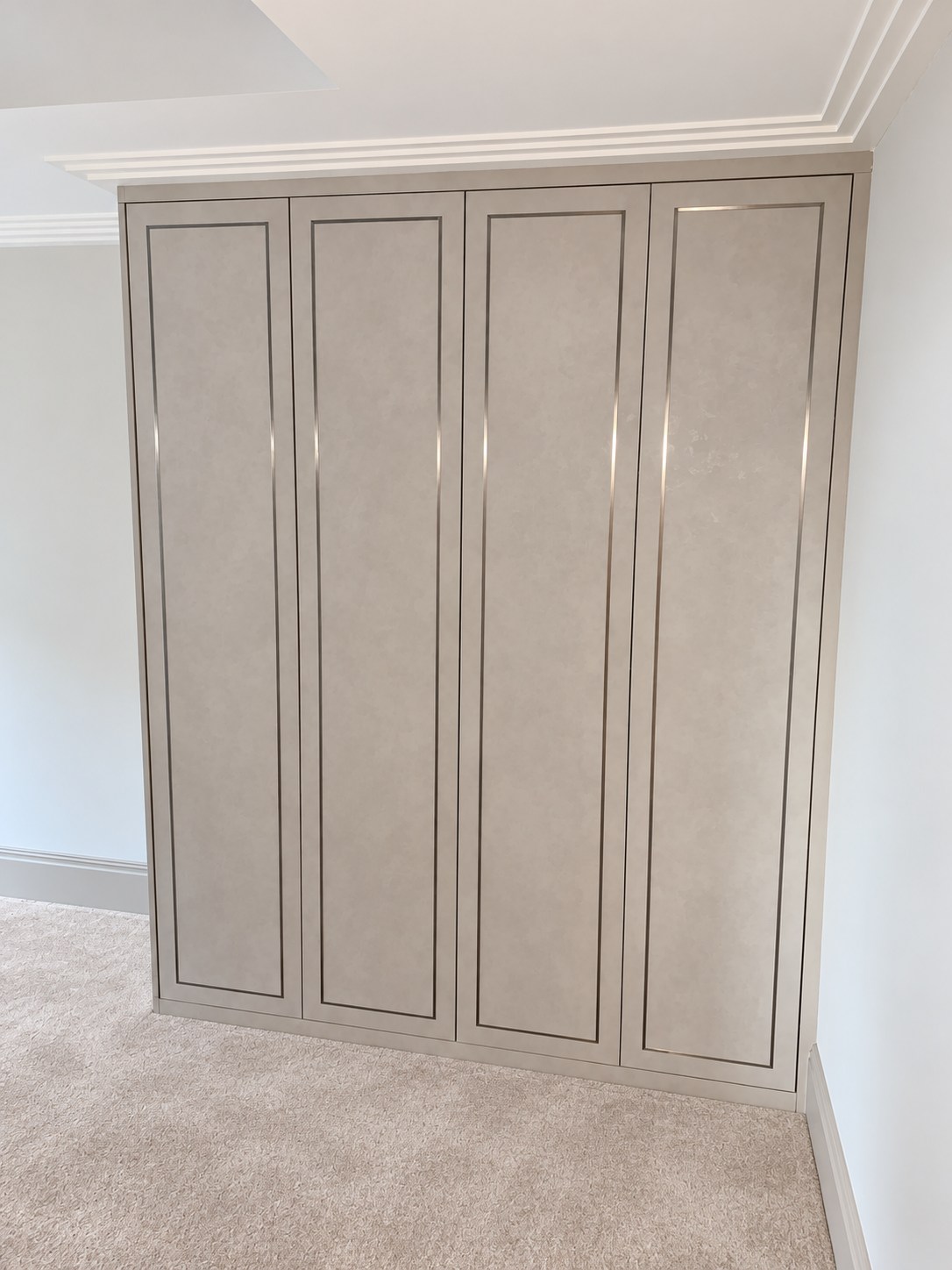 Four wardrobe doors with slim framed inlay and light grey concrete texture
