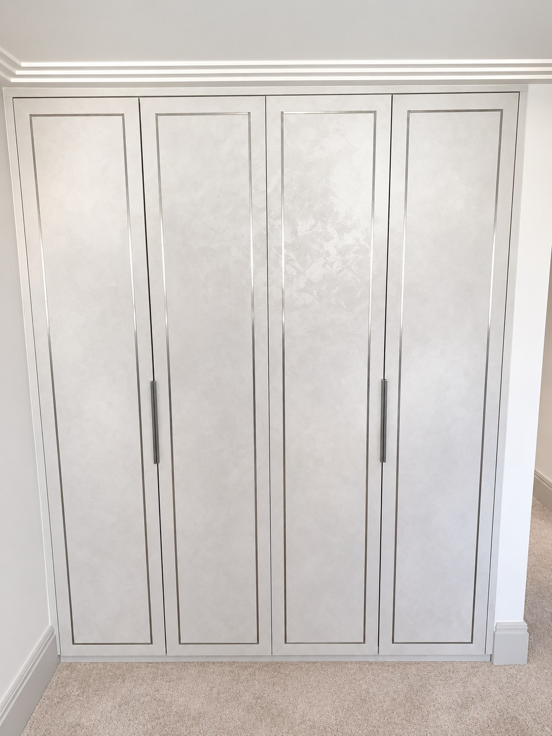 Four wardrobe doors showing the concrete texture and slim inlay design