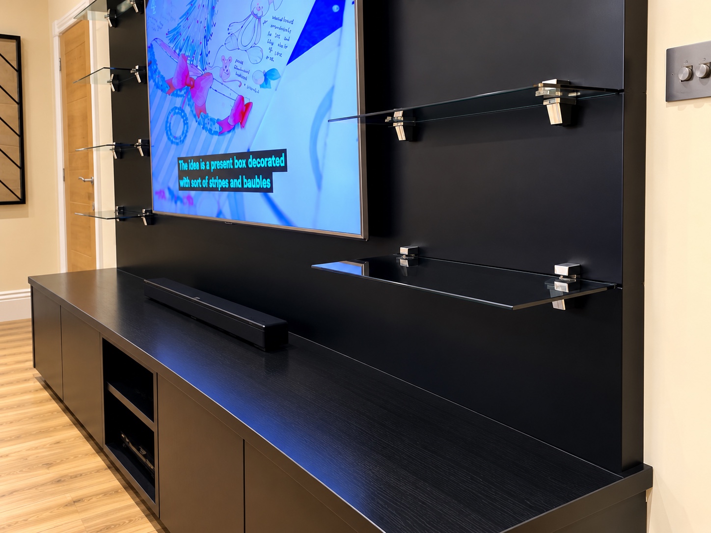 Glass shelf and black media cabinetry detail