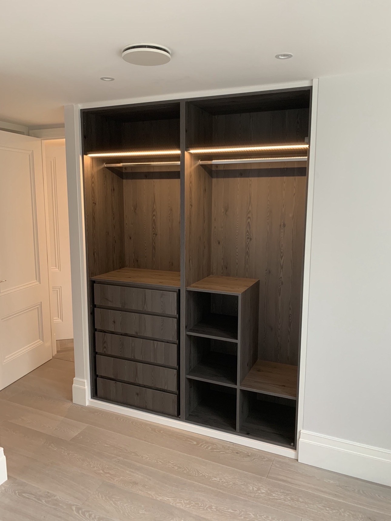 LED-lit fitted wardrobe with black Sorano Oak interior in Westminster