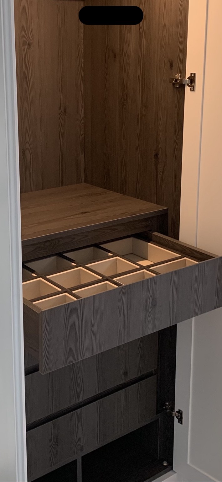 Detail of a compartmentalised soft-close wardrobe drawer